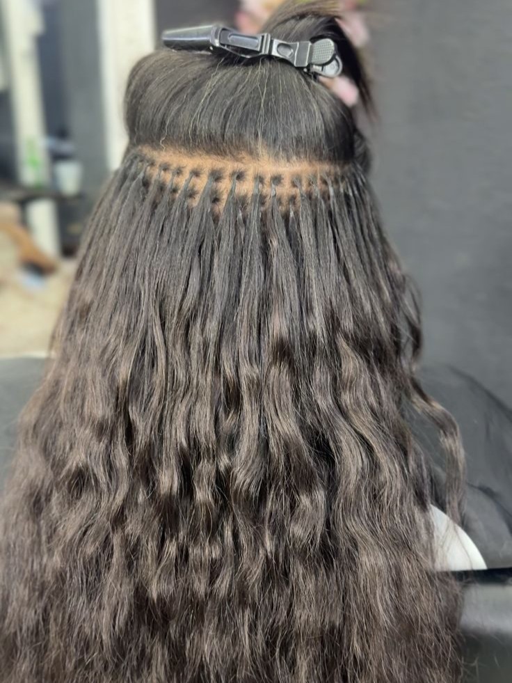 K-Tip keratin bond hair extensions being applied row by row